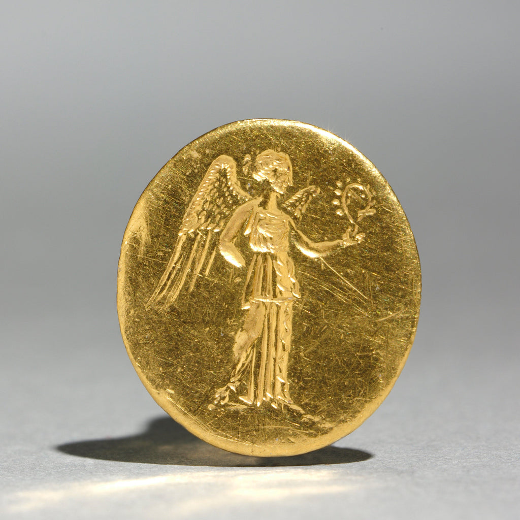 A gold signet ring shown from the front with an engraved figure of Nike from ancient Greece in the Cleveland Museum of Art