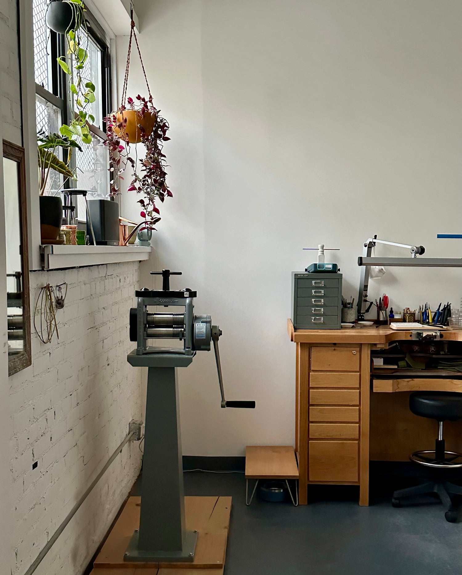 Rolling mill, jewelers’ bench, and goldsmithing tools in the Brooklyn studio of Alexis Menten Designs in New York City