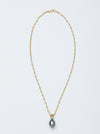 A necklace handmade by Alexis Menten with a gray South Sea pearl pendant resembling an ancient amphora shown from the front