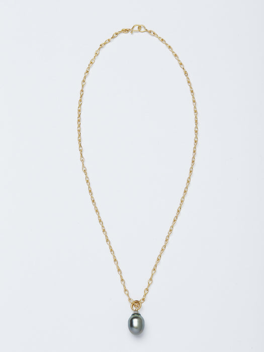 A necklace handmade by Alexis Menten with a gray South Sea pearl pendant resembling an ancient amphora shown from the front