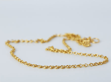 Apeiron Chain by Alexis Menten with intricate 22k gold links handmade in an ancient style shown in close up
