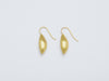 Cylichna Earrings by Alexis Menten with 22k gold cylinders with tapered ends handmade in an ancient style shown from the side