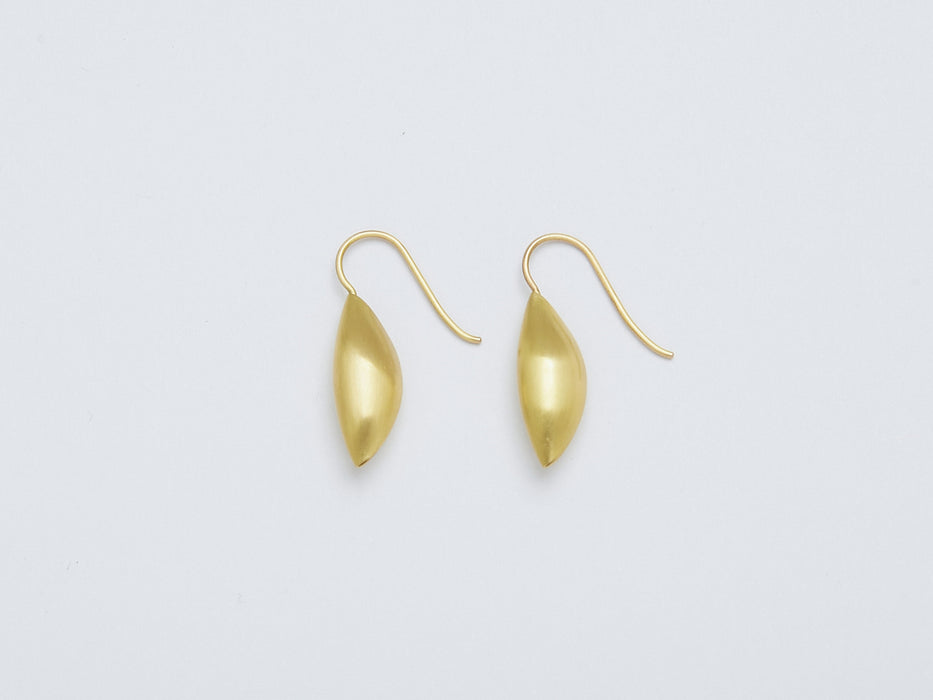 Cylichna Earrings by Alexis Menten with 22k gold cylinders with tapered ends handmade in an ancient style shown from the side