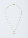 Lunula Necklace by Alexis Menten with a 22k gold crescent shaped pendant handmade in an ancient style shown from the front