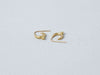 Mari Earrings handmade by Alexis Menten with 22k gold ancient style crescent hoops and granules shown lying on their sides