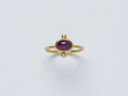 Satnal Ring by Alexis Menten handmade in an ancient style with 22k gold, a ruby, and two granules shown from the front