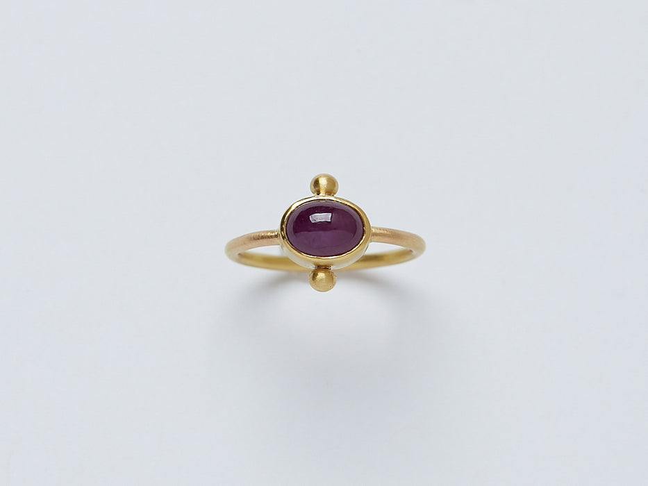 Satnal Ring by Alexis Menten handmade in an ancient style with 22k gold, a ruby, and two granules shown from the front