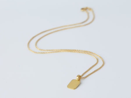 Stele Necklace by Alexis Menten with a rectangular 22k gold pendant handmade in an ancient style shown from the side