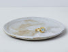 Thyra Ring by Alexis Menten handmade in an ancient style with 22k gold and aquamarine displayed on a ceramic dish